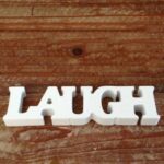 Dřevěný nápis LAUGH (smích)
